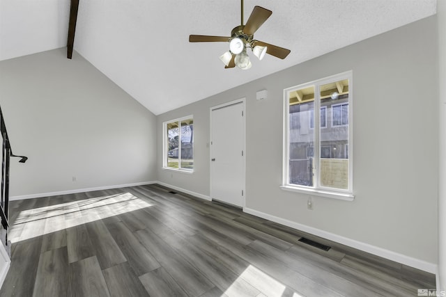 interior space featuring lofted ceiling with beams, ceiling fan, dark hardwood / wood-style flooring, and a textured ceiling