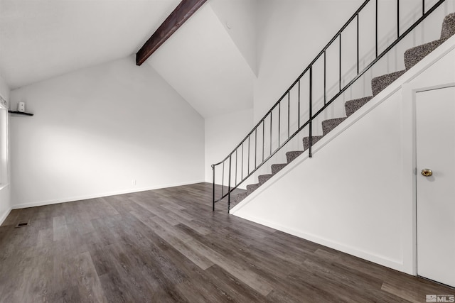 interior space featuring dark hardwood / wood-style floors, beam ceiling, and high vaulted ceiling