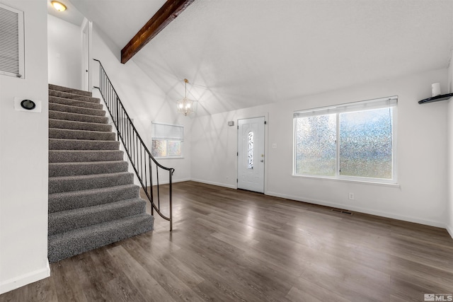 foyer featuring a chandelier, vaulted ceiling with beams, and dark wood-type flooring