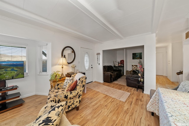 living room with beamed ceiling and light wood-type flooring