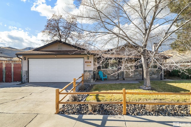 ranch-style house with a front yard and a garage