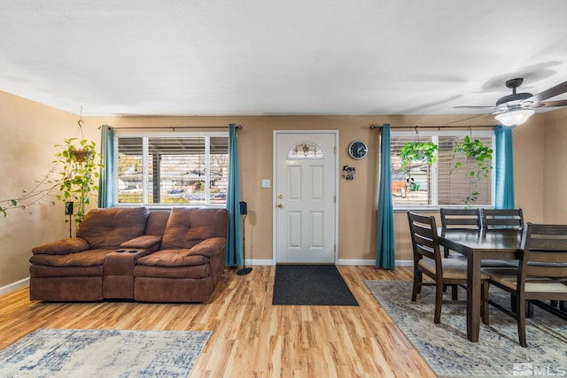 living room featuring hardwood / wood-style floors and ceiling fan