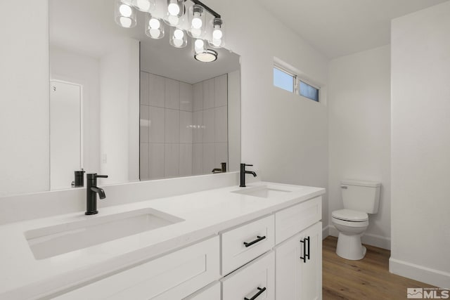 bathroom with hardwood / wood-style flooring, vanity, and toilet