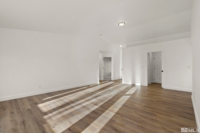 unfurnished room featuring hardwood / wood-style floors and vaulted ceiling