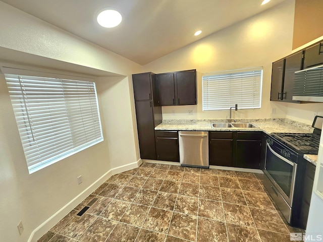 kitchen featuring dark brown cabinetry, sink, lofted ceiling, and appliances with stainless steel finishes