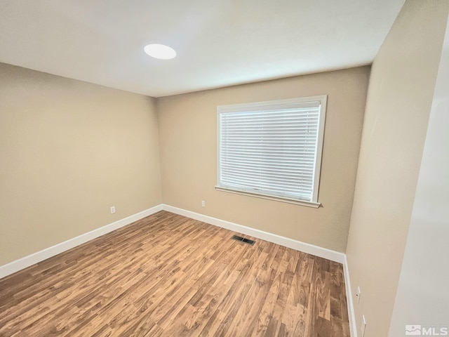 unfurnished room featuring hardwood / wood-style flooring