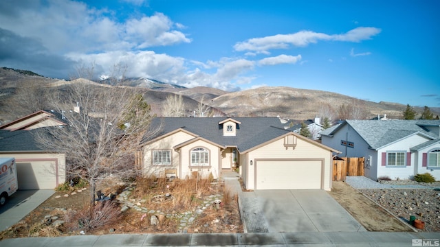 view of front of home featuring a mountain view and a garage