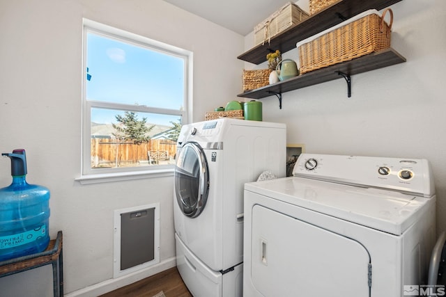 clothes washing area with dark hardwood / wood-style flooring and separate washer and dryer