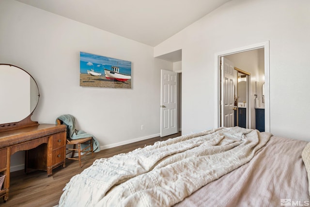 bedroom featuring connected bathroom, vaulted ceiling, and dark wood-type flooring