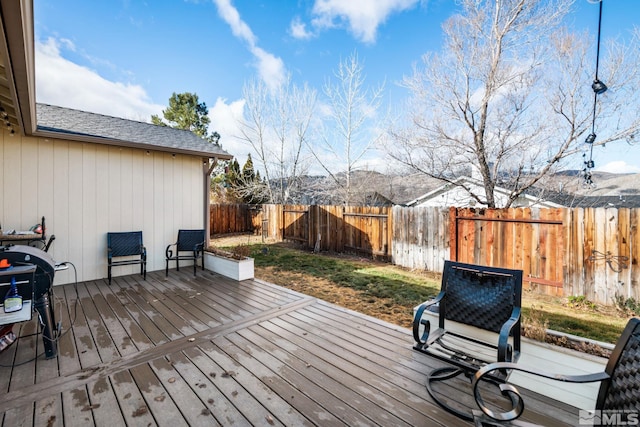 wooden deck with a grill