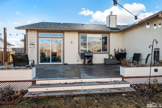 rear view of house with a wooden deck