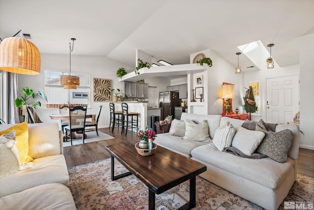 living room featuring hardwood / wood-style floors and vaulted ceiling