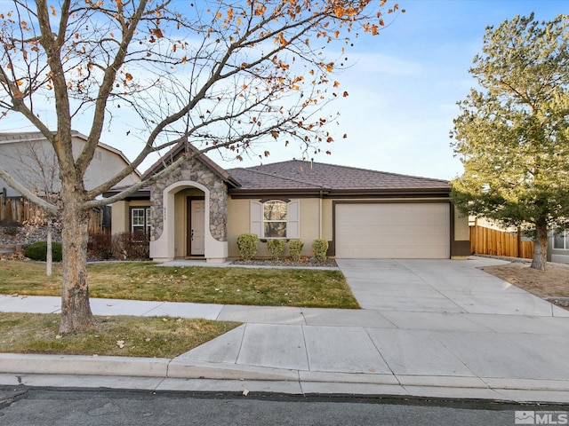 view of front of house featuring a front yard and a garage