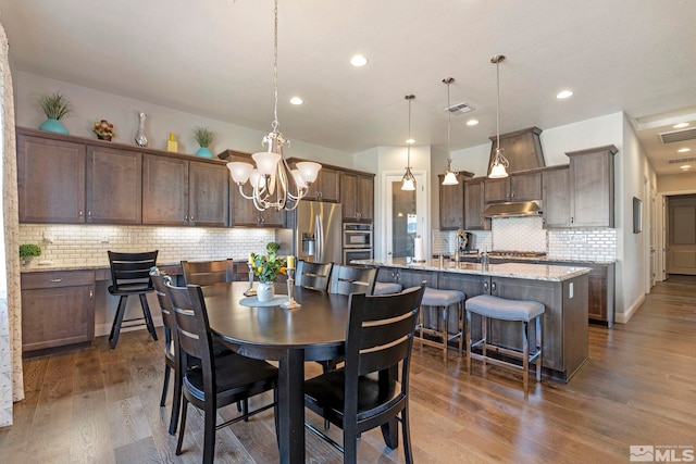 dining room with a chandelier and dark wood-type flooring