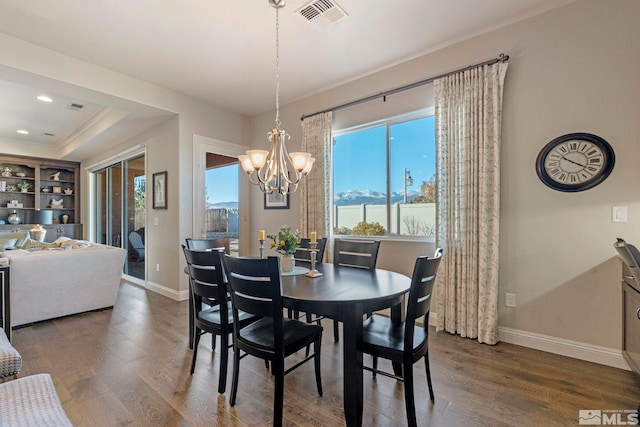 dining area with a chandelier and dark hardwood / wood-style flooring