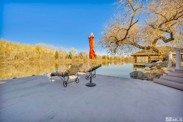 view of patio / terrace featuring a gazebo and a water view