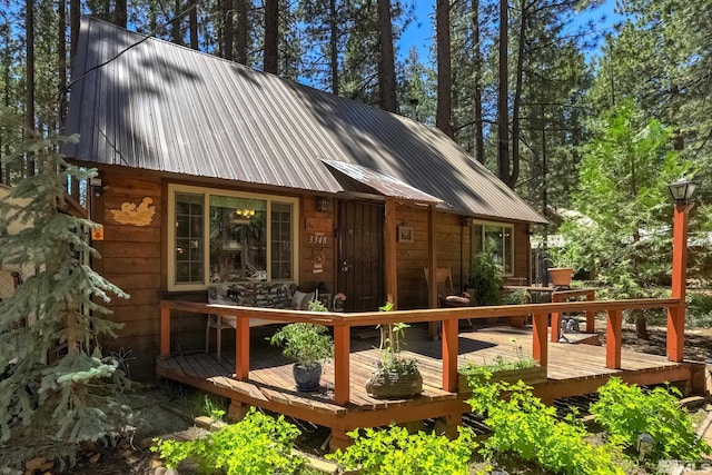 rear view of property featuring a wooden deck