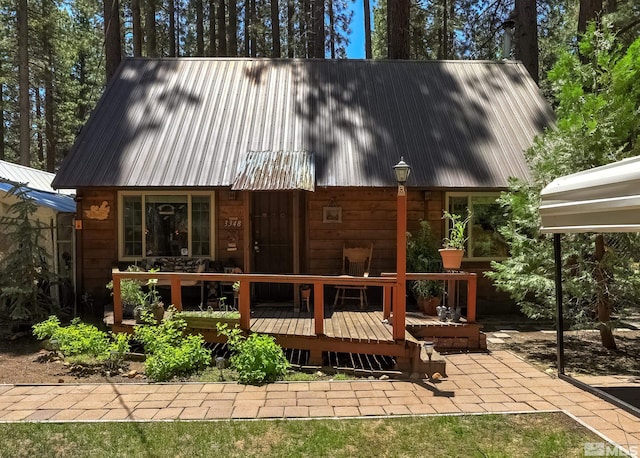 rear view of property featuring a wooden deck