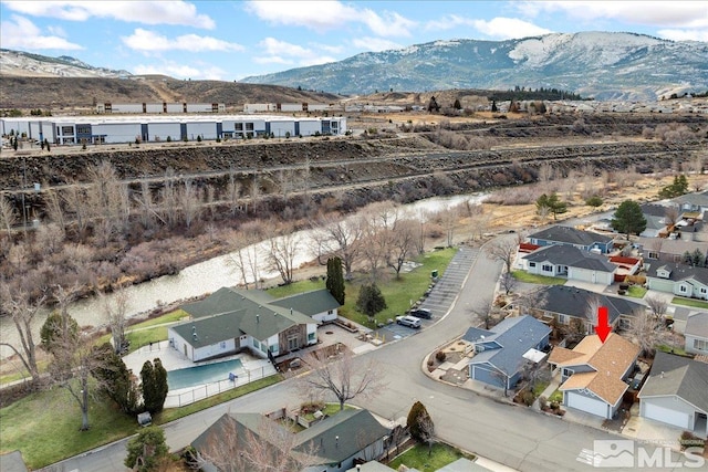 birds eye view of property with a mountain view