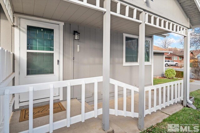 doorway to property featuring covered porch