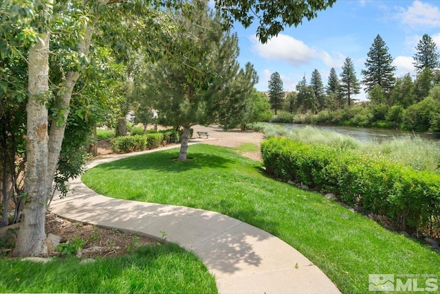 view of home's community featuring a yard and a water view