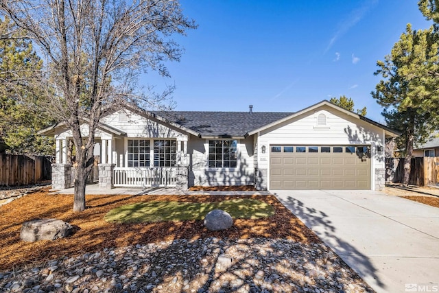 ranch-style home featuring covered porch and a garage