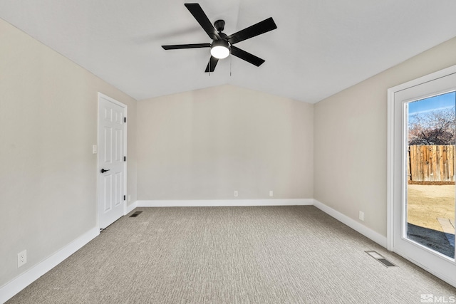 empty room with ceiling fan, light colored carpet, and vaulted ceiling