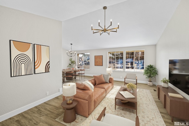 living room featuring light hardwood / wood-style flooring and an inviting chandelier