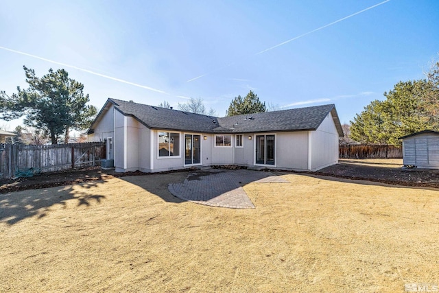 back of property featuring a patio area and a shed