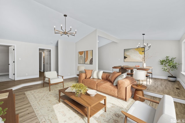 living room featuring light hardwood / wood-style floors, vaulted ceiling, and a notable chandelier