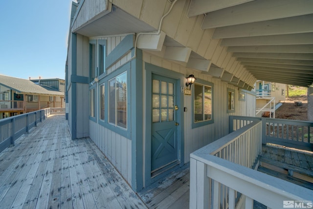 view of exterior entry with a wooden deck