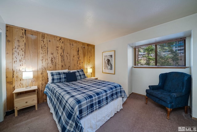 bedroom featuring carpet and wooden walls