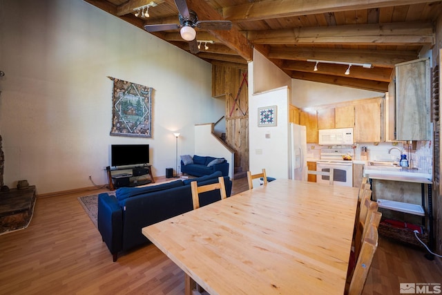 dining area featuring sink, vaulted ceiling with beams, ceiling fan, wood-type flooring, and wood ceiling