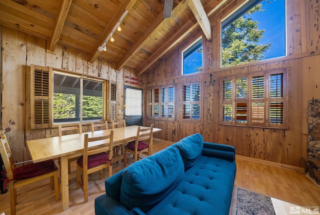 living room with wood-type flooring, rail lighting, wooden ceiling, and beam ceiling