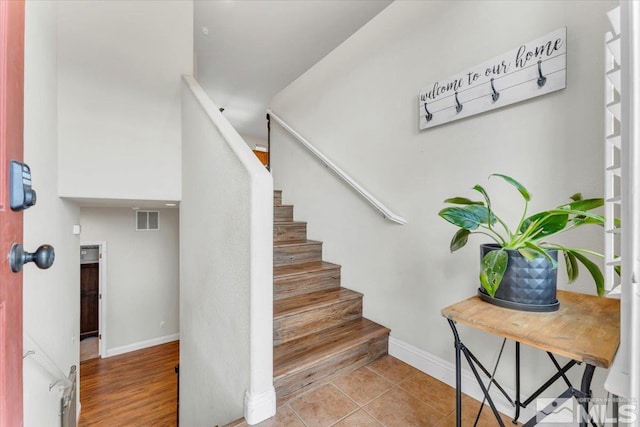 stairway with tile patterned flooring