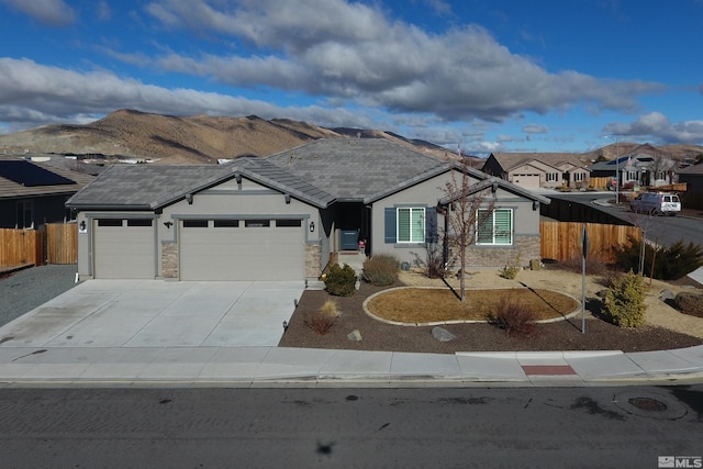 ranch-style home with a garage and a mountain view