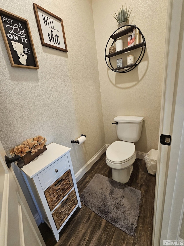 bathroom with hardwood / wood-style floors and toilet