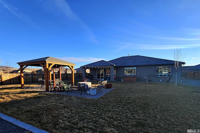 rear view of house featuring a lawn, a gazebo, and a patio