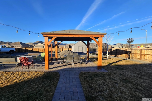 view of yard featuring a storage unit and a gazebo