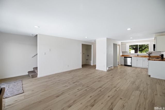 unfurnished living room featuring light hardwood / wood-style flooring and baseboard heating