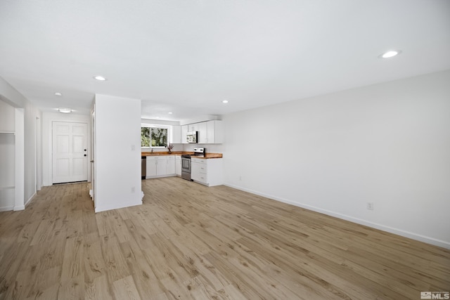 unfurnished living room with light hardwood / wood-style floors