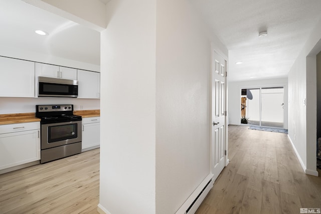 hall with light hardwood / wood-style flooring and a baseboard radiator