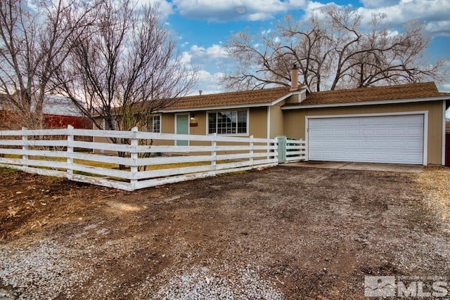 ranch-style home featuring a garage