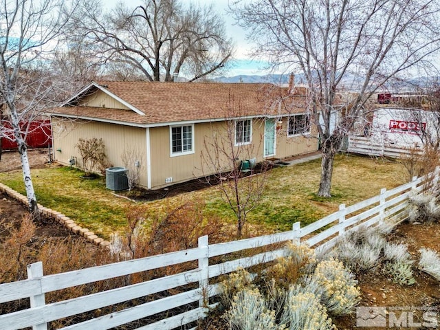 view of home's exterior featuring central air condition unit and a yard