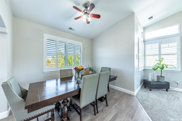 dining space with ceiling fan, plenty of natural light, light hardwood / wood-style floors, and lofted ceiling