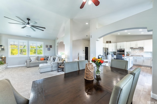 dining room with high vaulted ceiling and ceiling fan