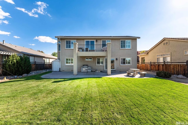 back of house with a yard, a patio, and a balcony