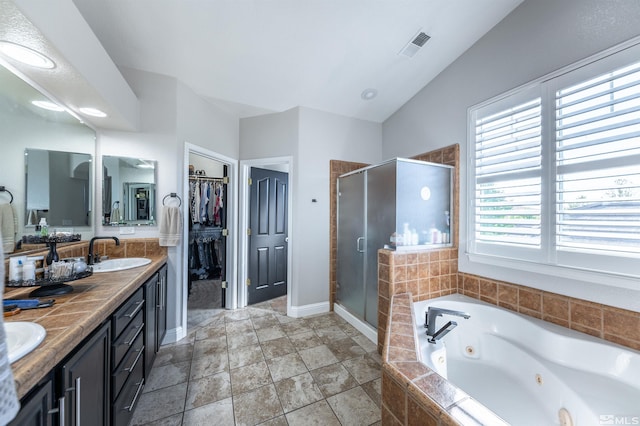 bathroom with vanity, lofted ceiling, and shower with separate bathtub