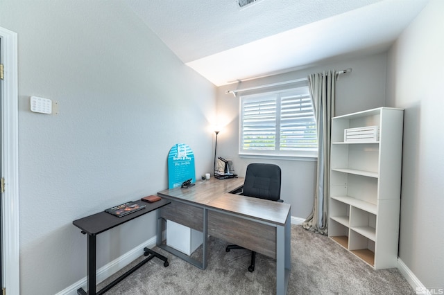 carpeted home office with lofted ceiling