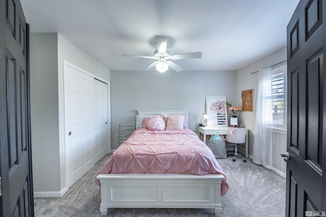 carpeted bedroom featuring a closet and ceiling fan